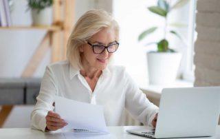 older woman using laptop computer for research