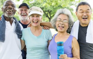 Group of senior friends exercising in park together