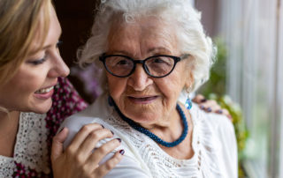 elderly mother and daughter sharing comforting moment