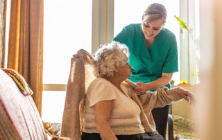 Nurse helps patient in nursing home